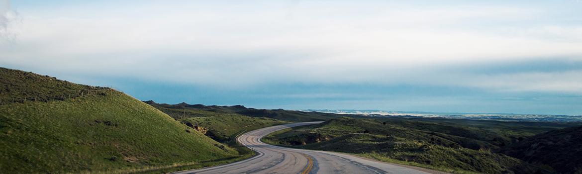 Open road winding into the hilly plains